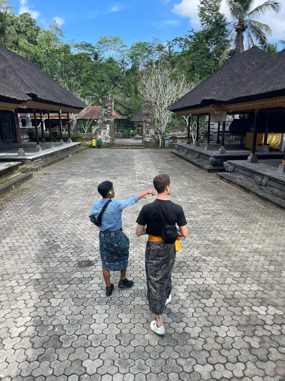 Guests exploring a Balinese temple with Awan